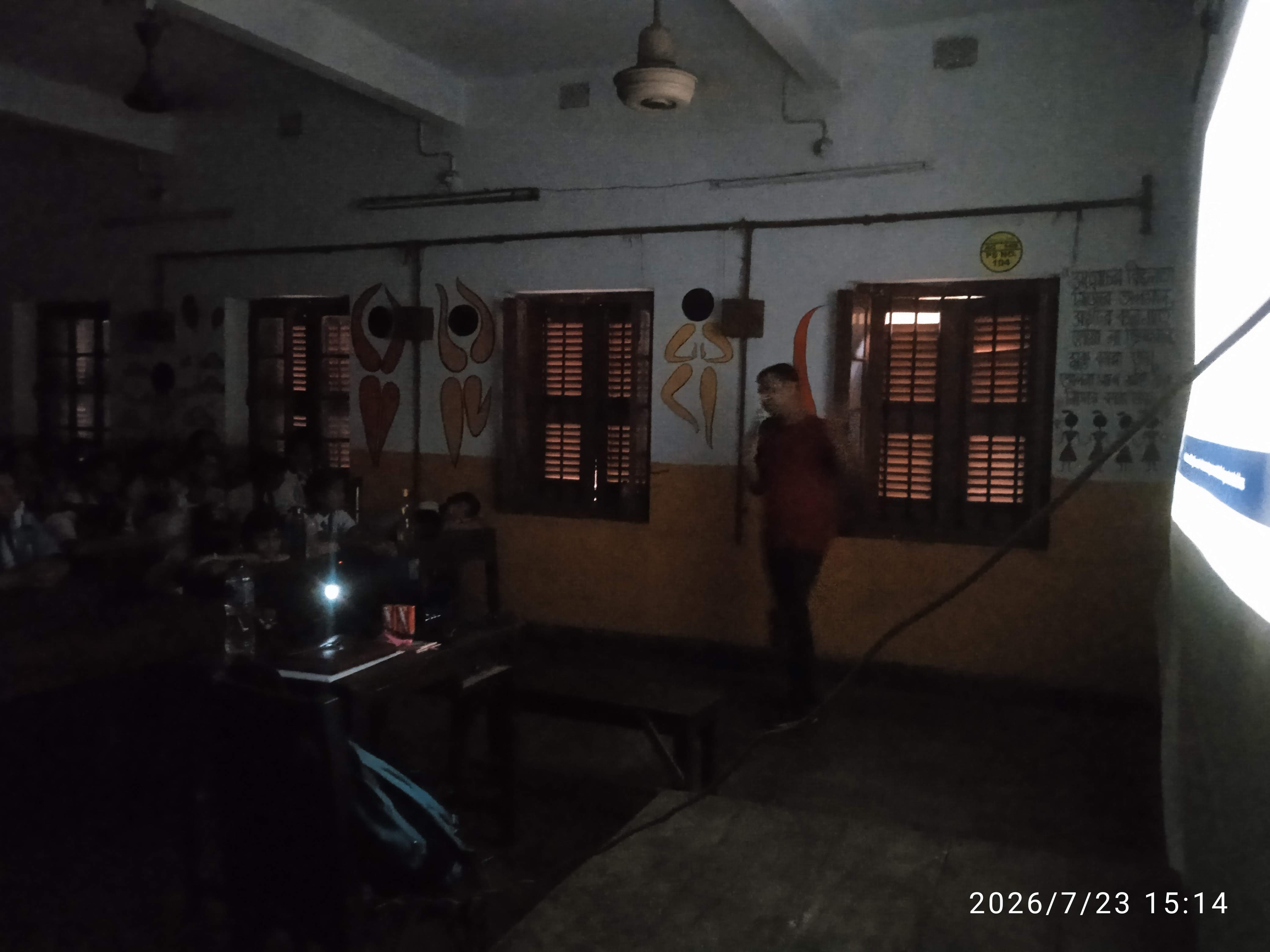 MAVI Foundation presenter continuing the workshop in low light at Ram Joy Seal Sishu Pathsala, 2026 (photo 10 of 10)