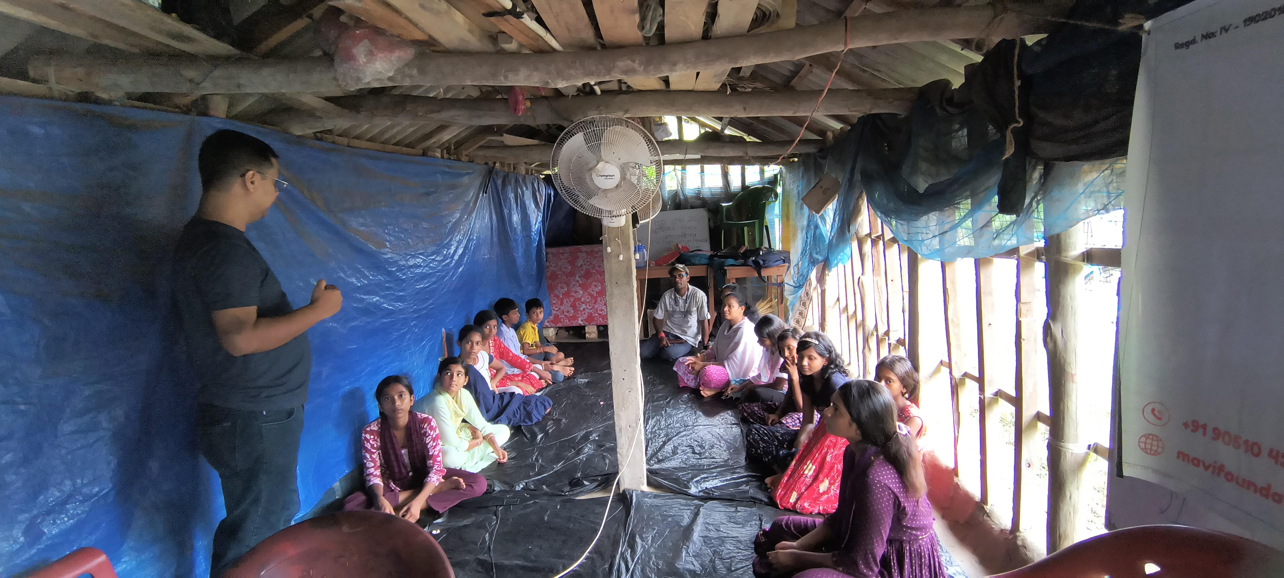 Students listening from every corner of the pathsala hut during the MAVI Foundation Information Security workshop in Gosaba Block, Sundarbans, 2026 (photo 5 of 8)