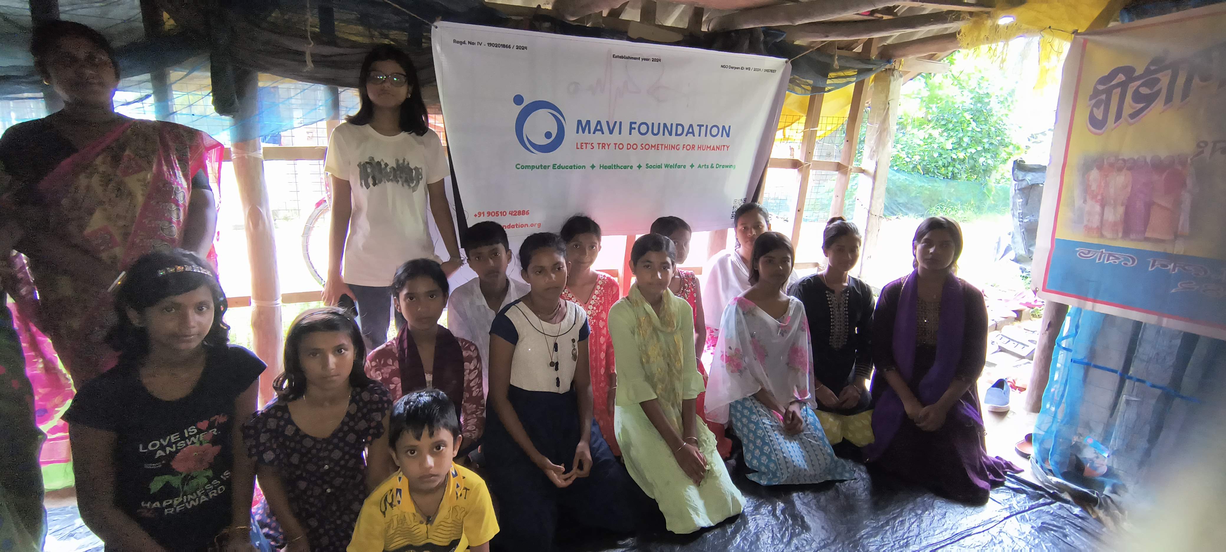 Students of the rural pathsala with the MAVI Foundation banner after the cyber fraud awareness workshop in Gosaba Block, Sundarbans, 2026 (photo 7 of 8)